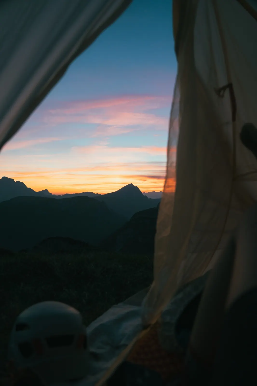View of the sunset from inside a tent in the Dolomites