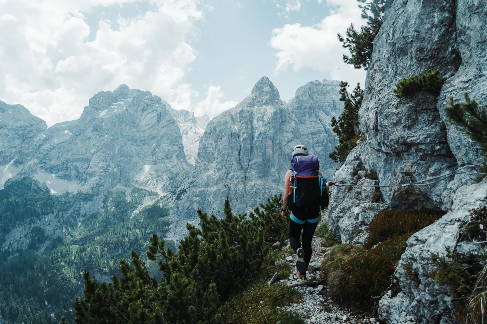 Walking along a narrow path beside the rock