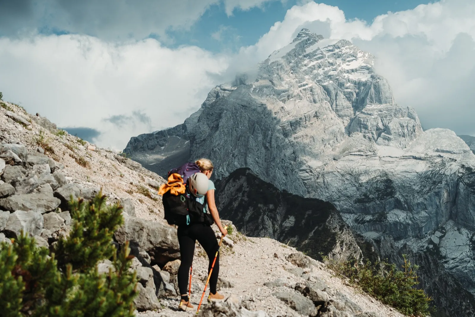 Hiker on a path with the Monte Antelao massif in the background