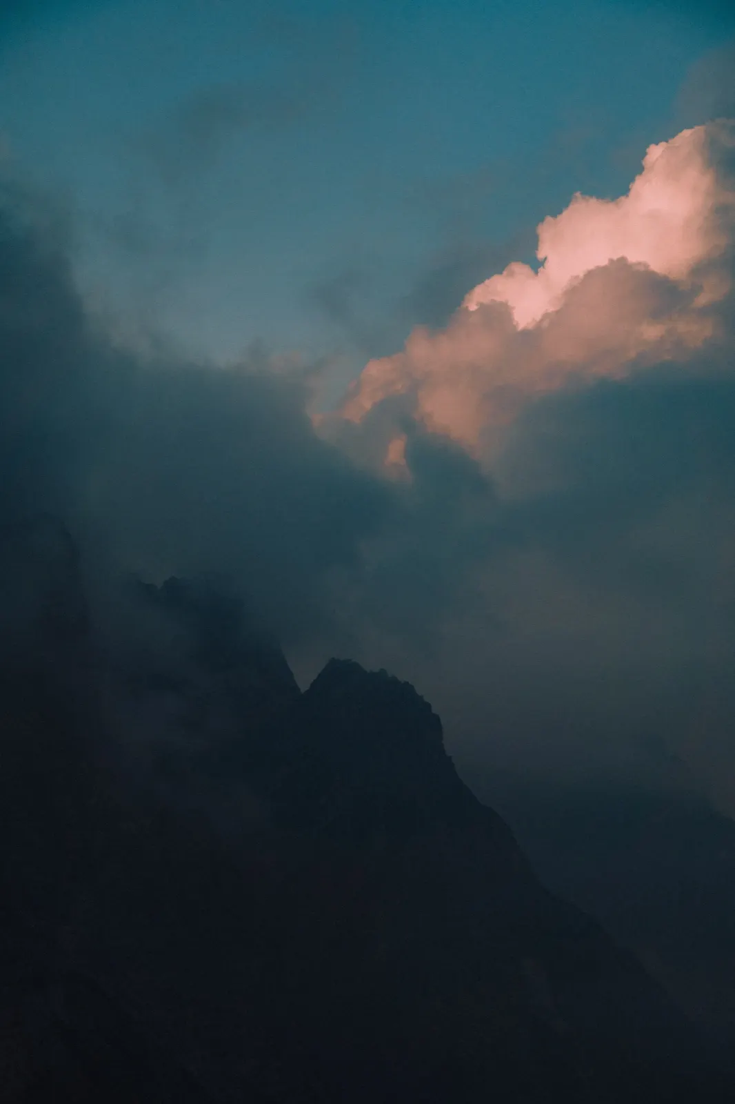 Fog and dramatic evening sunlight over the mountain peaks