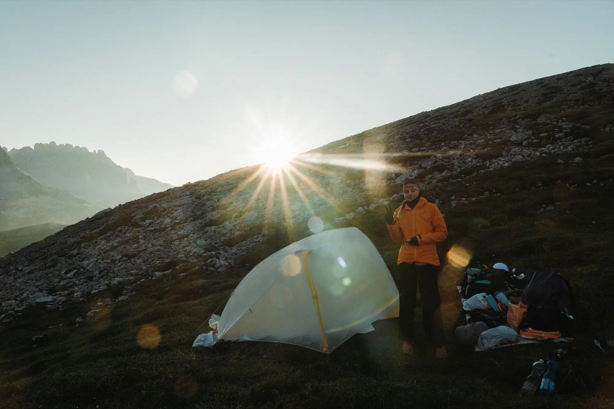 Sun flaring over a Tiger Wall UL2 pitched on a mountain ridge
