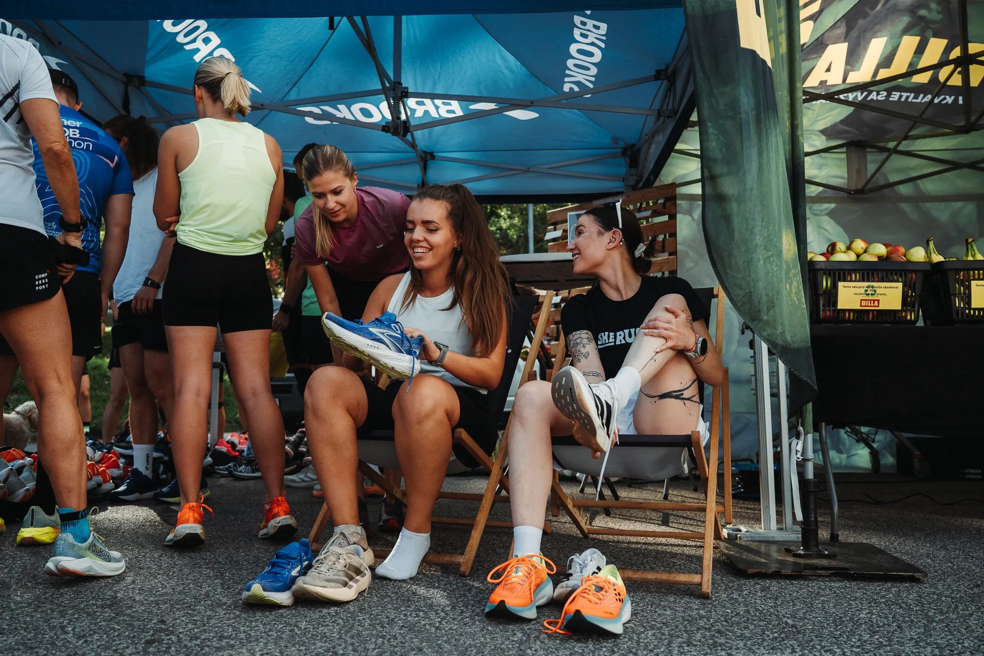 Runners resting under a blue tent after the social run