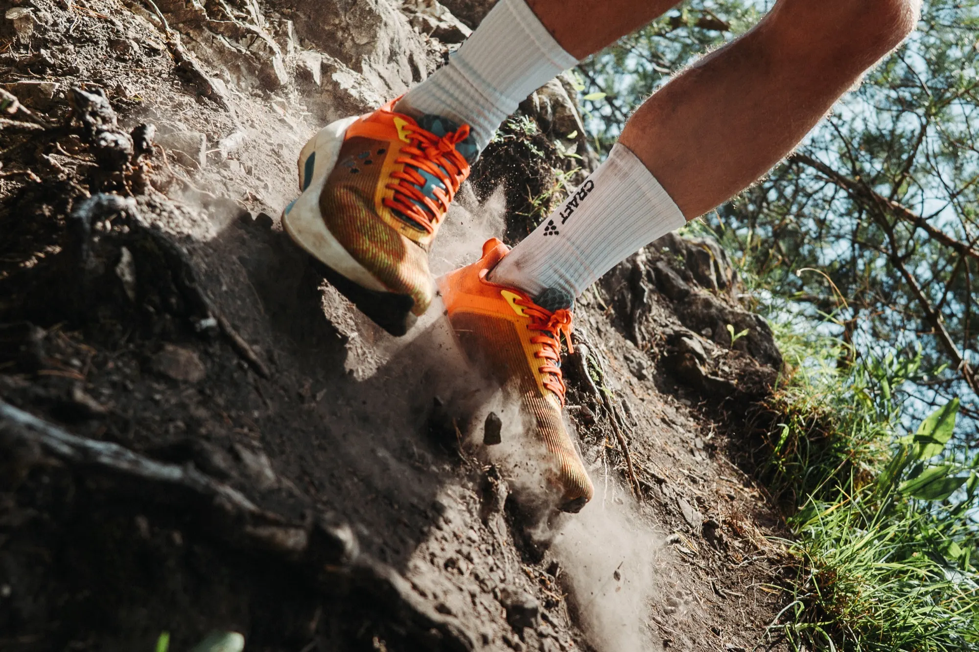 Hands adjusting an orange Craft Nordlite Ultra 2 on a rocky wall