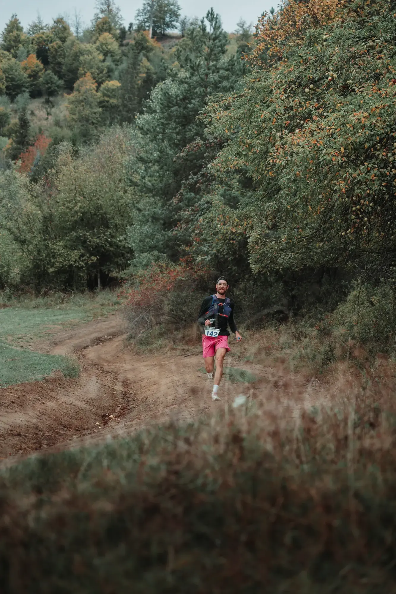 Runner on a narrow path through tall grass