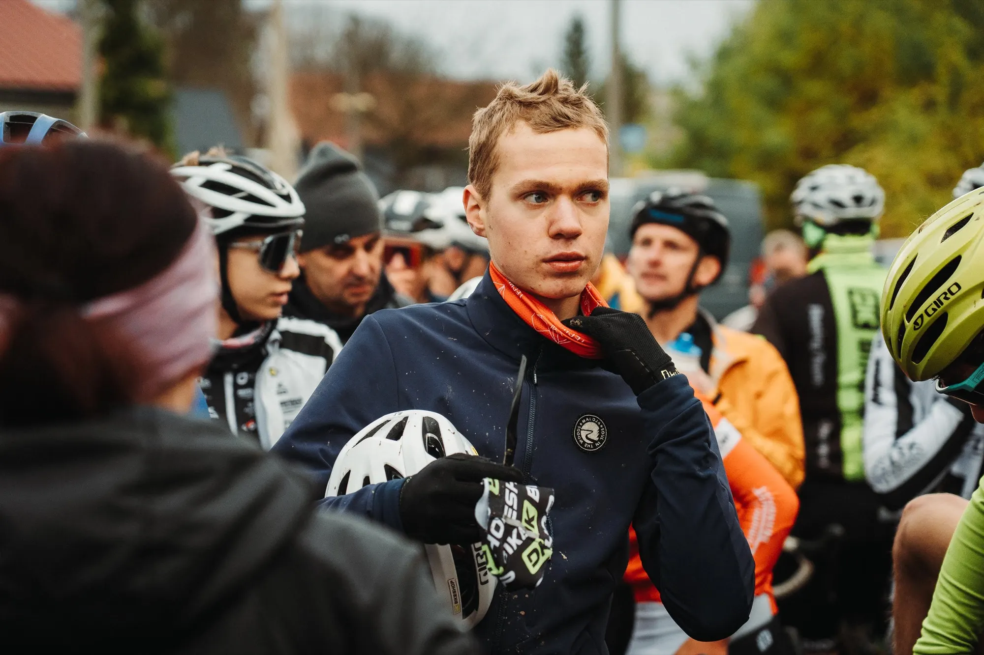 Rider in a dark jacket among competitors at the start line